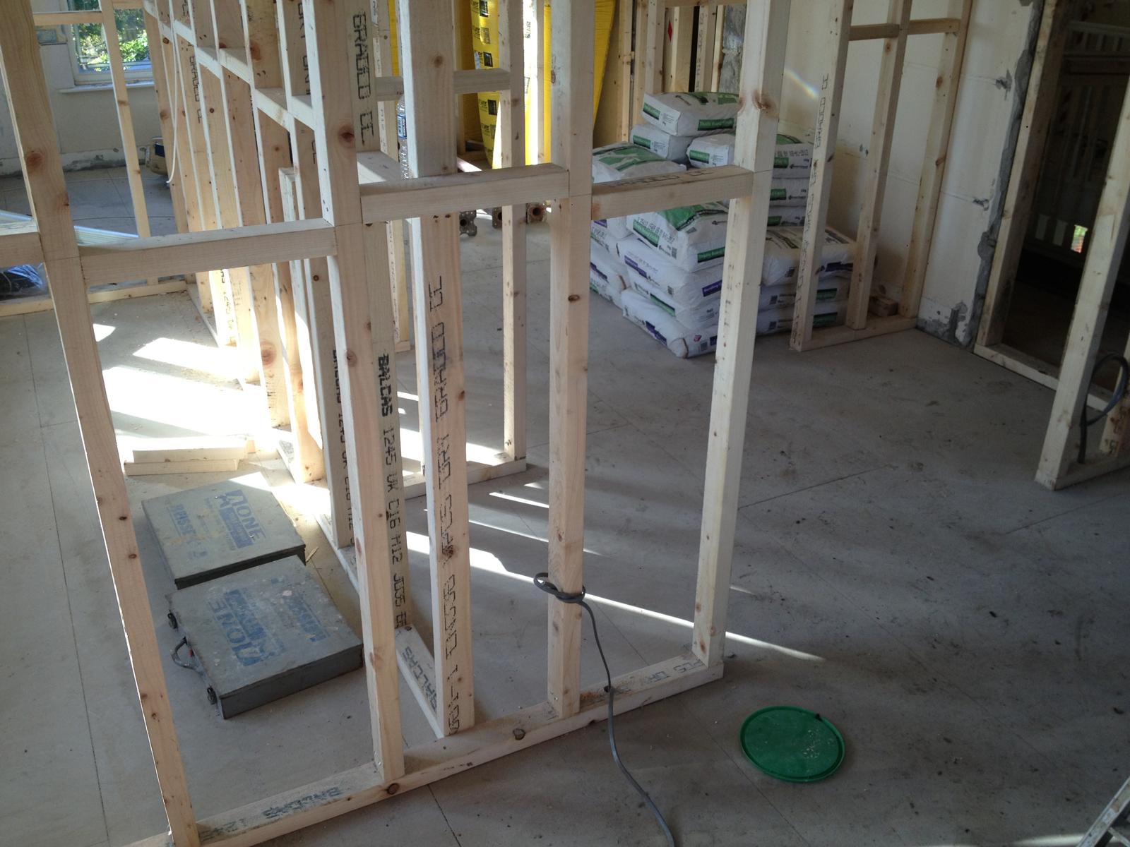 New internal layout set out in timber stud with plasterboard and bagged plaster materials on site ready for second-fix and finishing trades.