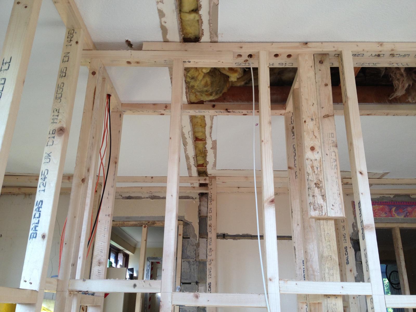 C16 timber stud walls built off new floors to form re-planned rooms, with first-fix services running through the framing ready for boarding.