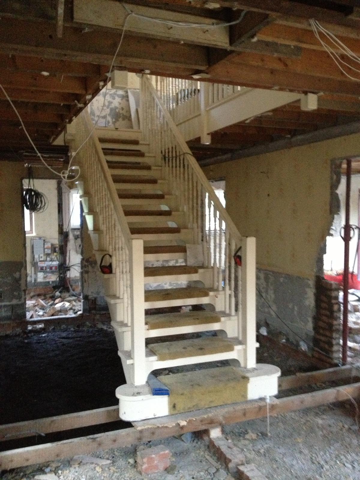 Existing staircase boxed and protected while surrounding walls, ceilings and floors were stripped back for a full internal refurbishment.